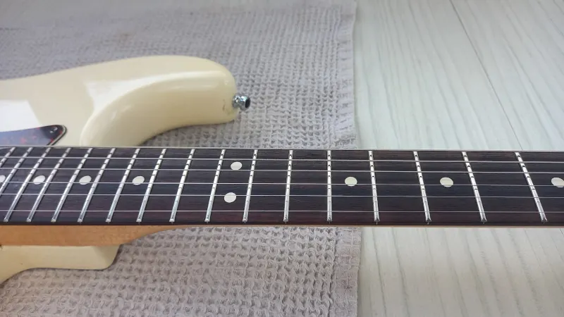 A cleaned and polished guitar fretboard