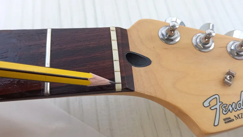 Putting graphite into a guitar nut slot