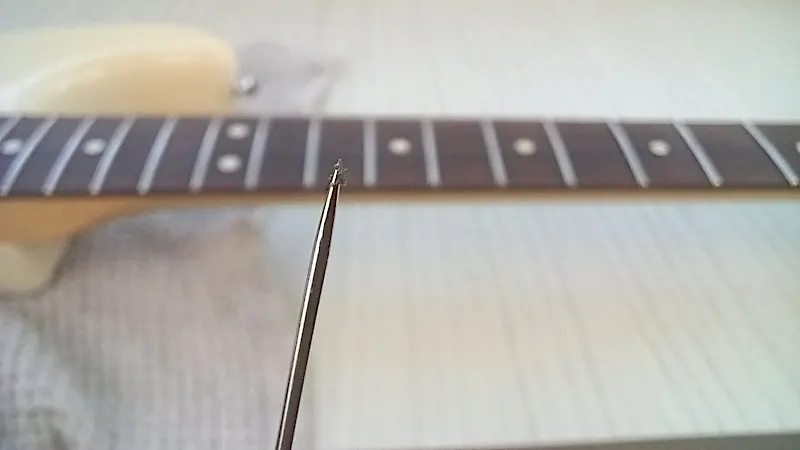 fretboard dirt on a pin