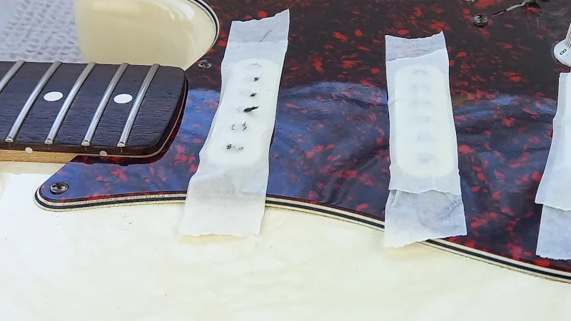 metal filings on a guitar pickup