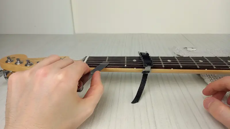 Checking guitar nut depth