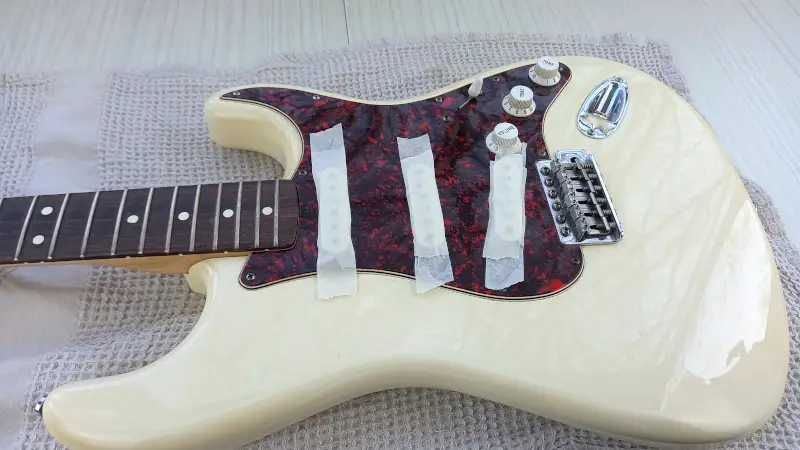 a guitar with taped pickups