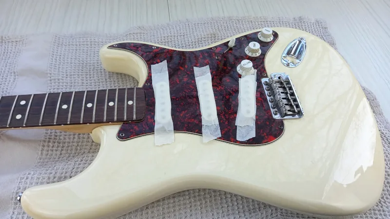 a guitar with taped pickups