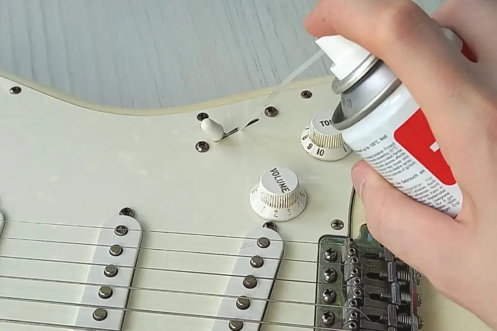 Using switch cleaner on a guitar