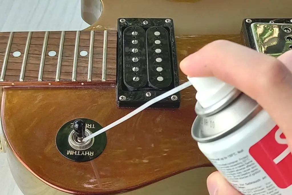 Using switch cleaner on a guitar
